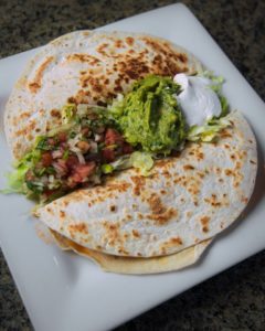 Fajita Quesadilla With choice oí meat. Two flour tortillas stuffed fajita-style. Served with onion, bell pepper, and cheese.